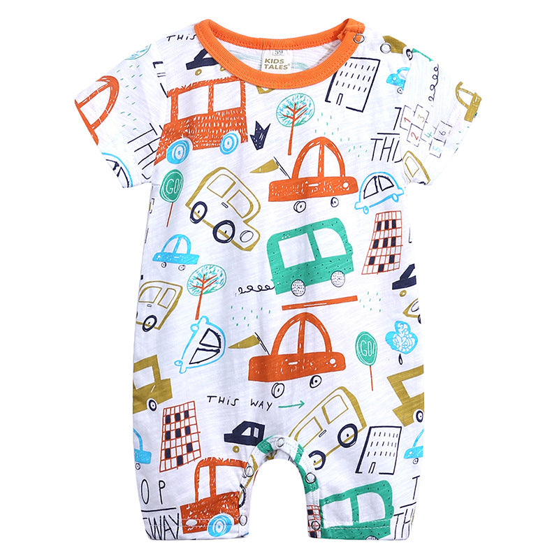 White baby romper with colorful car and building doodles. It features an orange neckline and buttons on the shoulder. The design includes trees and directional text for a playful look.