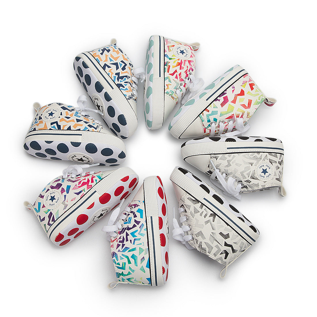 A circle of colorful toddler sneakers with various geometric and polka dot patterns, featuring brand logos on the sides and vibrant soles, arranged in an outward-facing pattern.