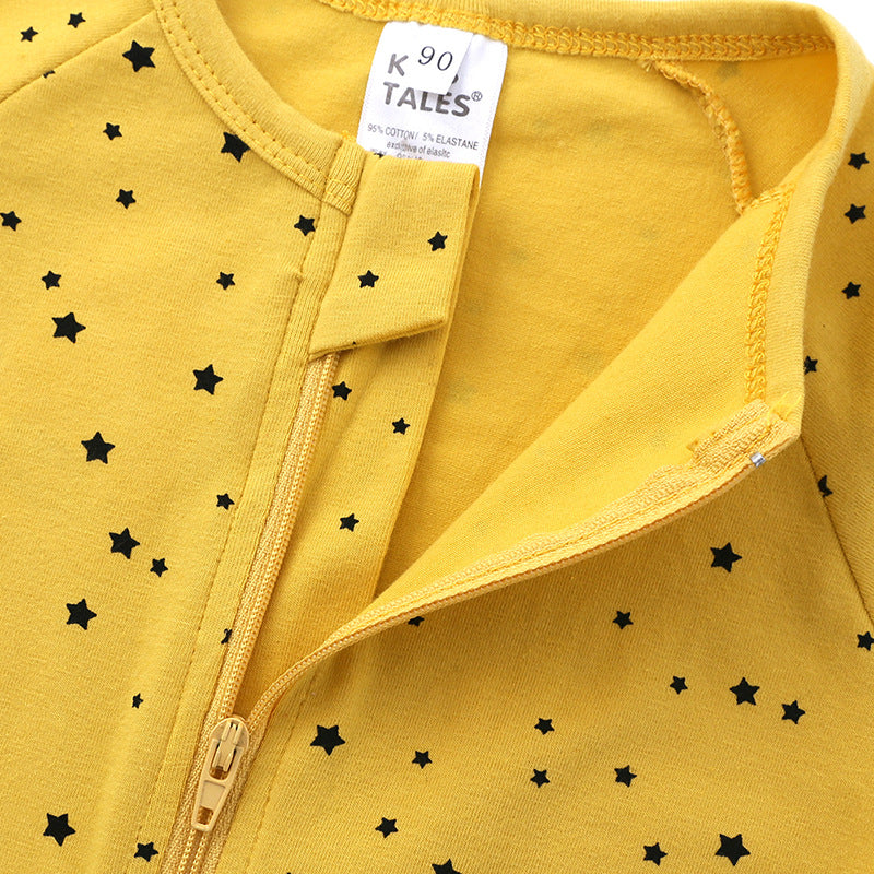 Yellow fabric with black star pattern, featuring a zipper and a label marked "90" and "Tales," made of 95% cotton and 5% elastane.