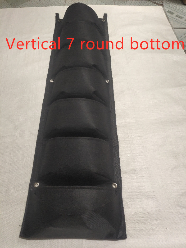 Black fabric wall planter with seven vertical pockets, rounded at the bottom, displayed on a white surface. Red text reads "Vertical 7 round bottom."