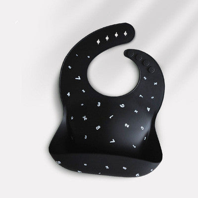 Black silicone bib with white numbers and symbols scattered across. It features an adjustable neck strap with multiple buttons and an integrated pocket for catching spills.
