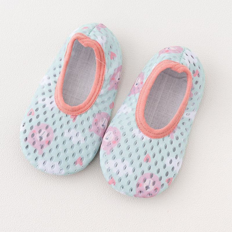 Pair of mint green children's shoes with pink trim and playful animal face prints, featuring a breathable mesh design, displayed on a light surface.