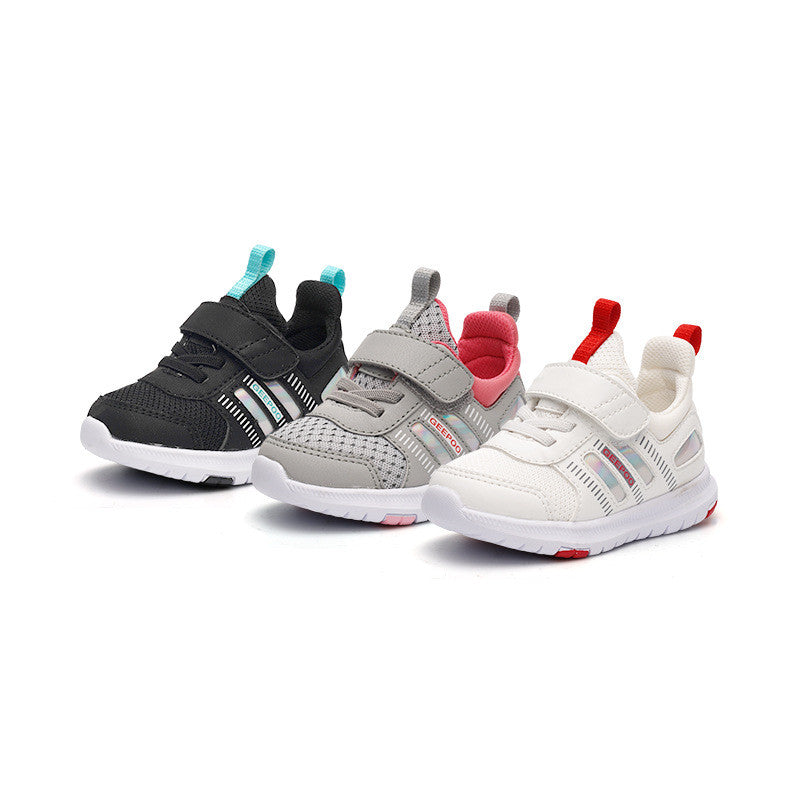 Three pairs of kids' sneakers in black, gray, and white colors with Velcro straps and colorful accents, displayed against a white background.