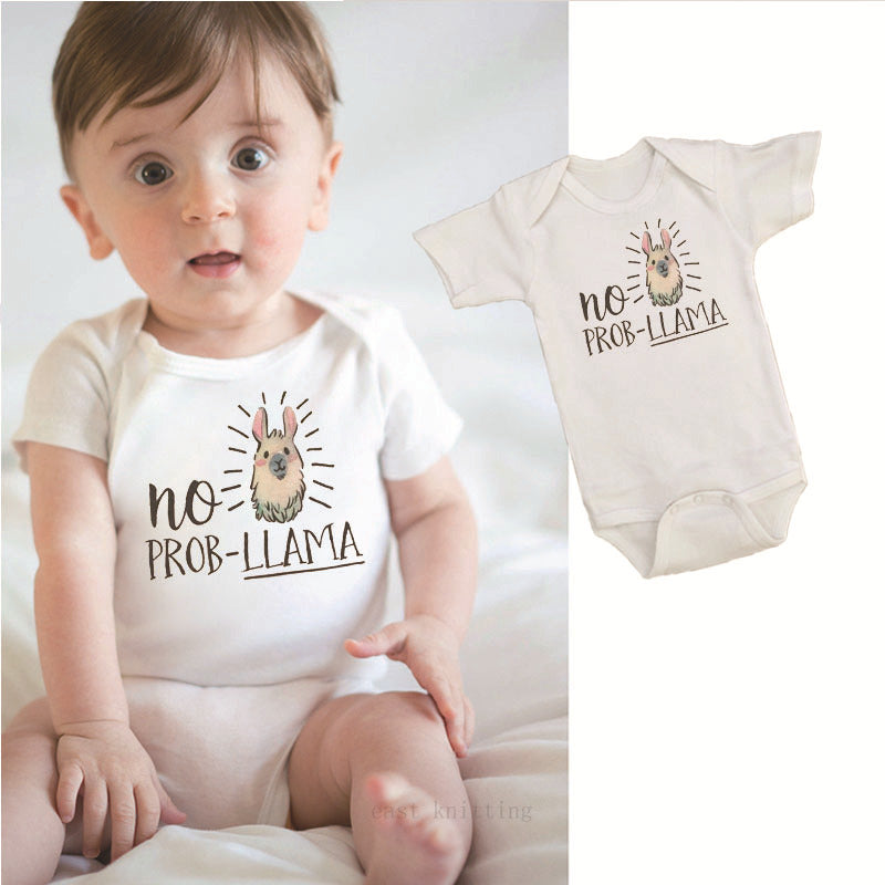 Baby wearing a white onesie featuring a llama illustration with text "no prob-llama." The same onesie is displayed alongside, highlighting the cute design.