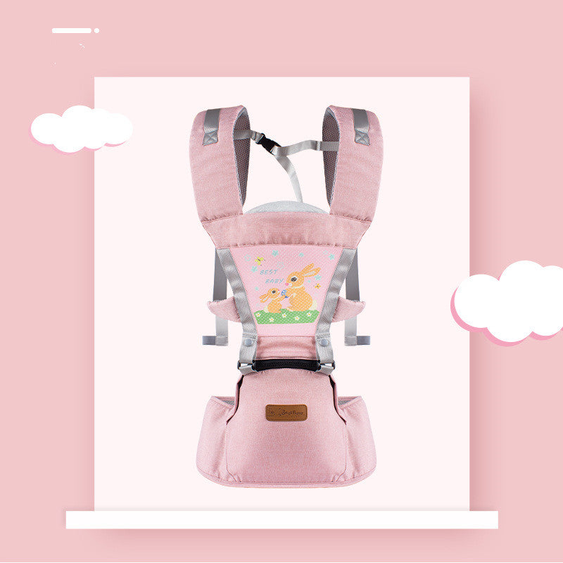 Pink baby carrier with adjustable straps, featuring a cute rabbit design on the front. It has a cushioned seat and a small pocket, set against a pink background with white clouds.