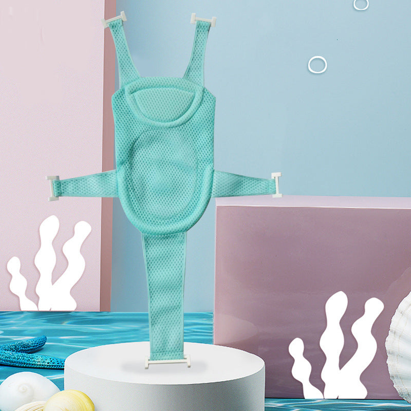 Aquatic-themed scene featuring a mint green baby bath seat with adjustable straps displayed on a white pedestal. The background has pastel pink and blue panels with coral illustrations.