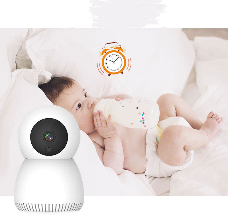 A baby lies on a bed drinking from a bottle. An alarm clock graphic above suggests a feeding schedule. A white baby monitor is in the foreground, highlighting a watching function.