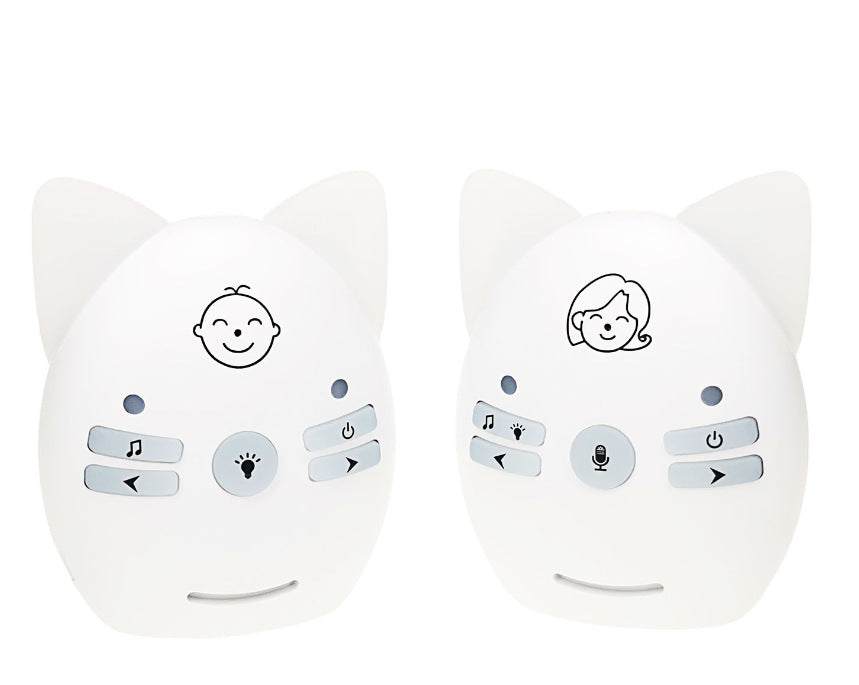 Two white, cat-eared baby monitors with smiling face icons. Each has buttons for music, light, and power. The left one has a baby face; the right one, an adult face.