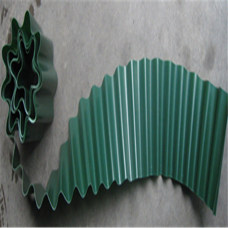 Green corrugated strip laid flat with a spiral end, displaying a wavy pattern on a neutral surface. The material appears flexible, forming star shapes in the spiral section.