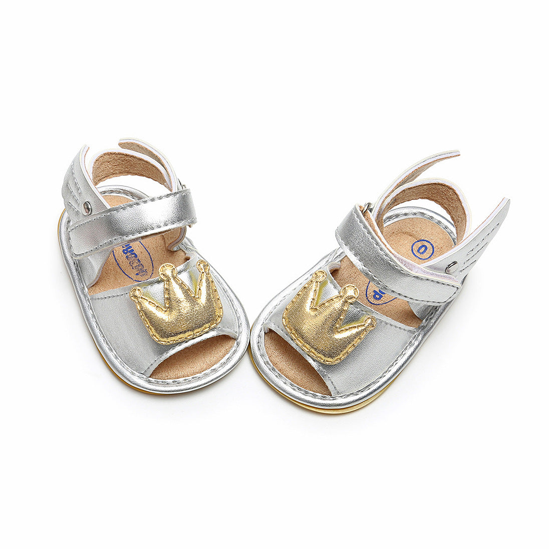 Silver toddler sandals with Velcro straps, featuring gold crown appliqués on the toes, displayed against a white background.