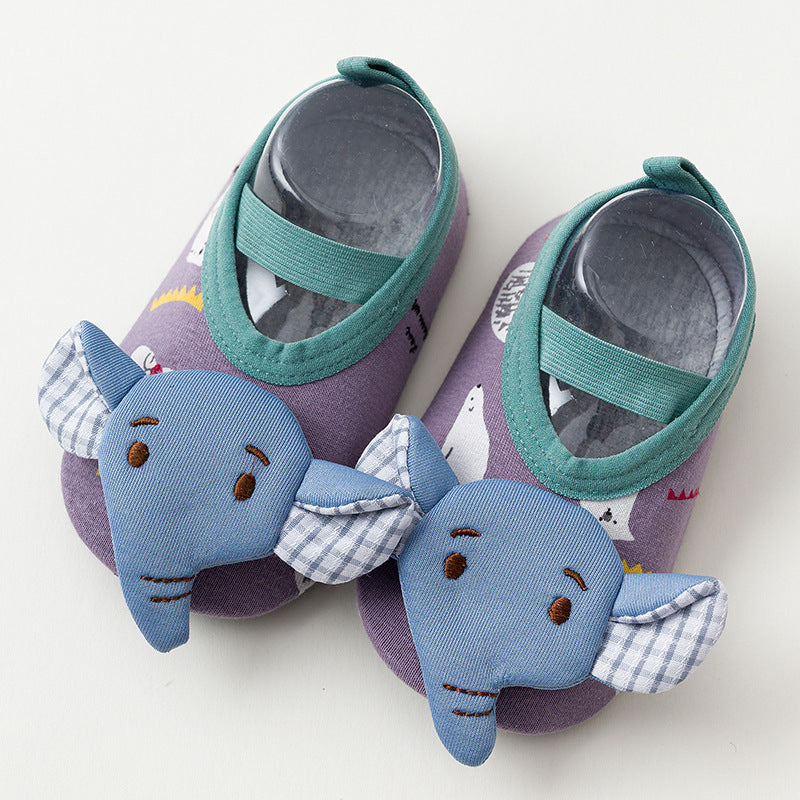 Purple baby shoes with teal straps, featuring blue elephant faces with checkered ears on the toes, and a pattern of white bears on the fabric.