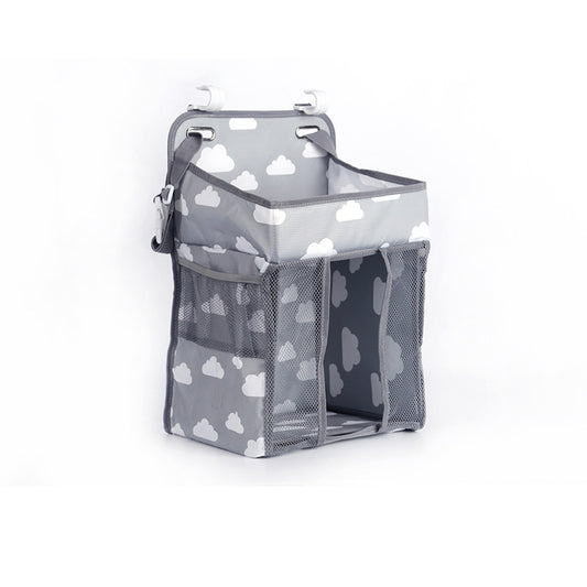 Gray hanging organizer with a cloud pattern, equipped with mesh pockets and two hooks on top. Suitable for storing small items, ideal for nurseries or bathrooms.