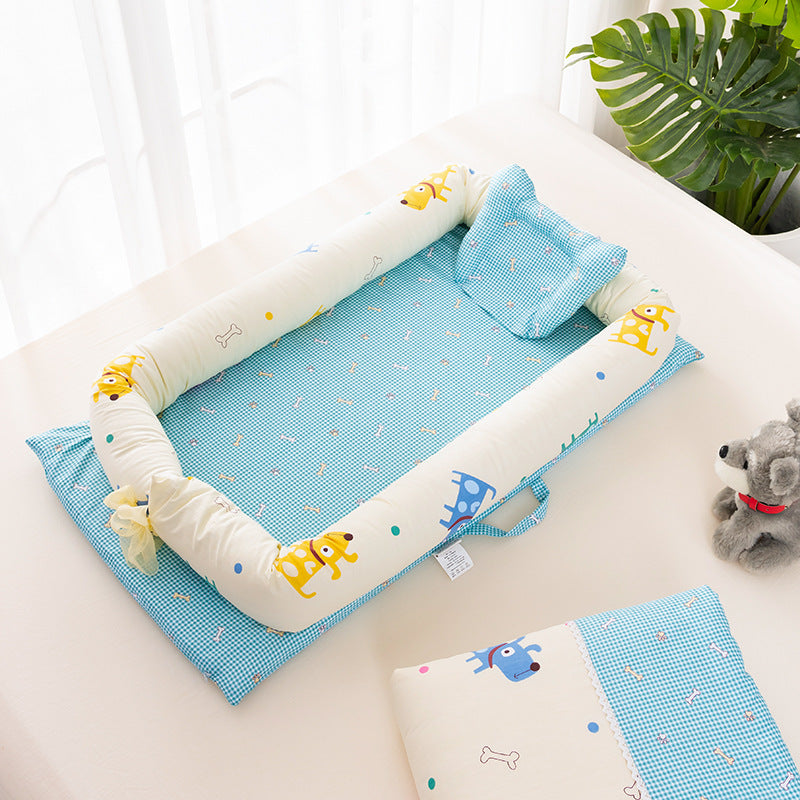 Baby play mat with blue and white checkered pattern, yellow and blue animal prints, surrounded by a cushioned bumper. Nearby is a toy dog and a green plant leaf.