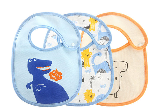 Three baby bibs featuring dinosaur designs: a blue one with a cute dinosaur and "Are you happy?" text, a multicolored with various dinos, and a beige bib with an orange trim.