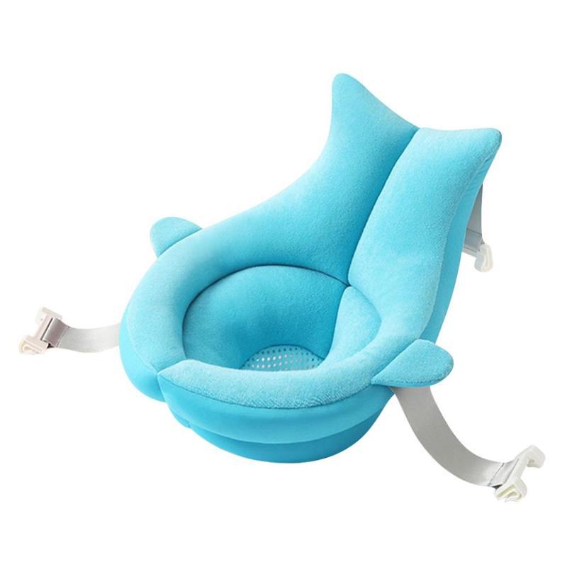 Blue baby bath seat with a plush, ergonomic design and suction cup attachments for stability. The seat features a central drain hole and side straps for secure placement.