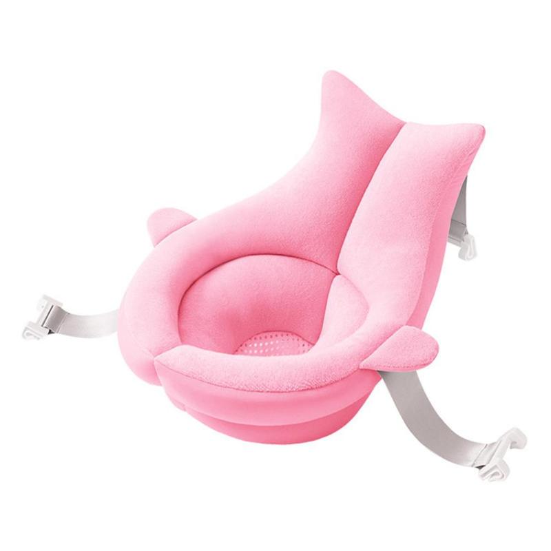 Pink baby bath seat with cushioned support, featuring soft fabric and rounded edges. It includes safety straps and clips for stability. Ideal for infant bathing.