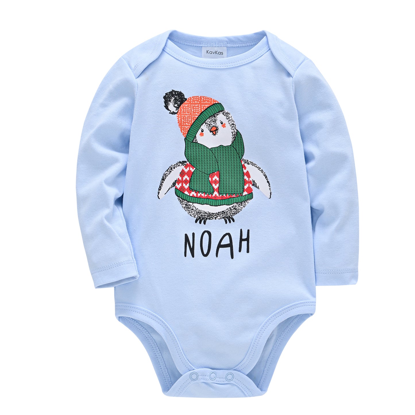 Light blue baby onesie with a penguin wearing a red hat and green scarf. The name "NOAH" is printed below in black letters. Long sleeves and snap closures at the bottom.