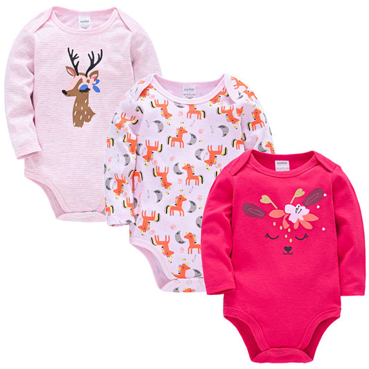 Three baby bodysuits: left pink with a deer, center white with unicorns and moons, right bright pink with a floral animal face. Each has long sleeves and snap closures.