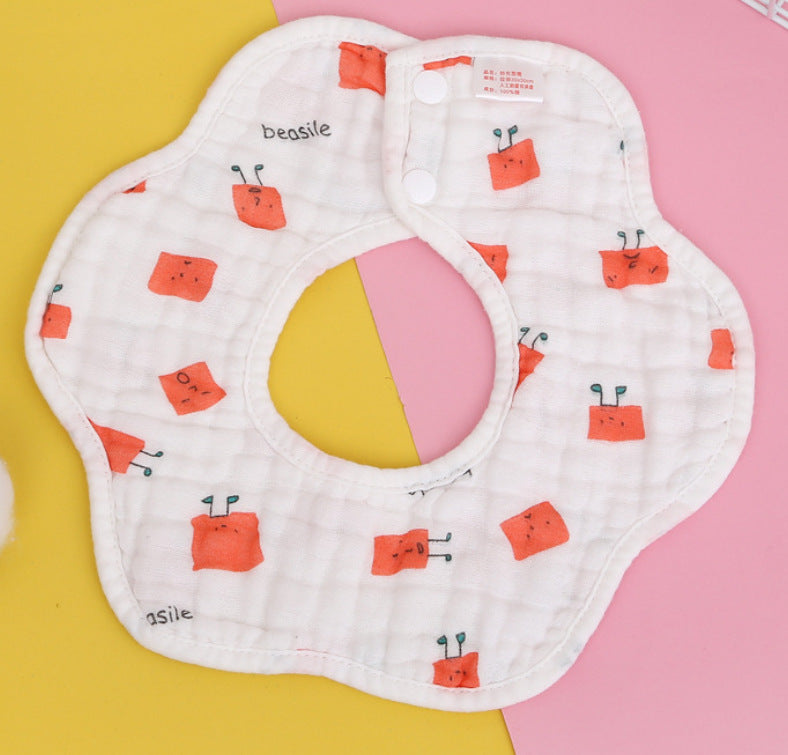 A flower-shaped baby bib with white fabric featuring cute orange square patterns and small text, "beasile," set against a pink and yellow background.