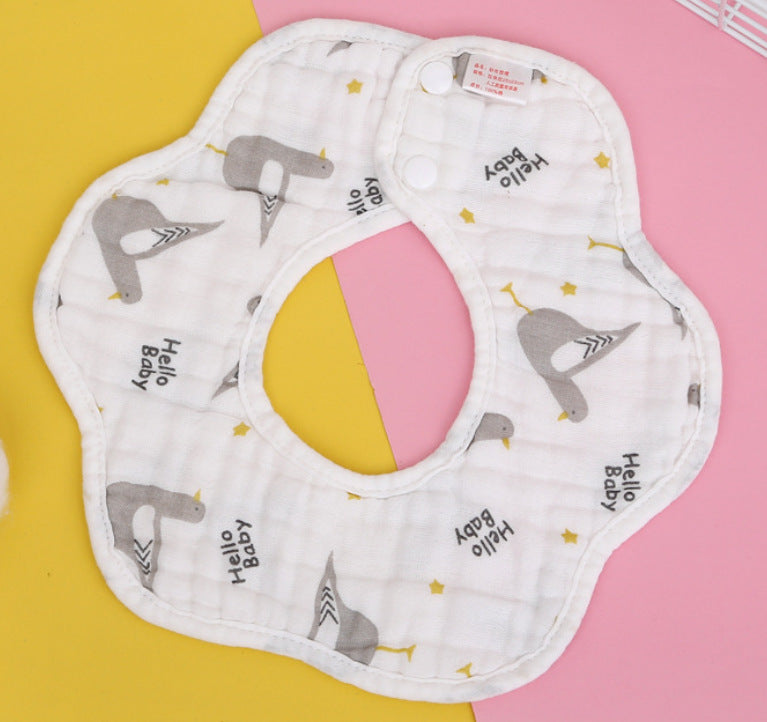 White flower-shaped baby bib with gray birds and "Hello Baby" text, decorated with yellow stars. Background is pink and yellow.