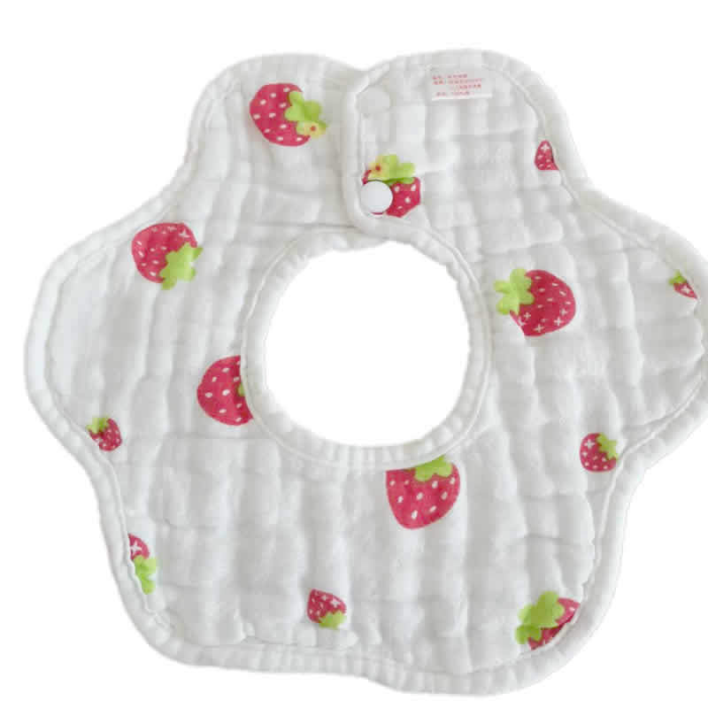 White baby bib with a floral shape, featuring a pattern of red strawberries with green leaves. It has a snap button closure near the top.