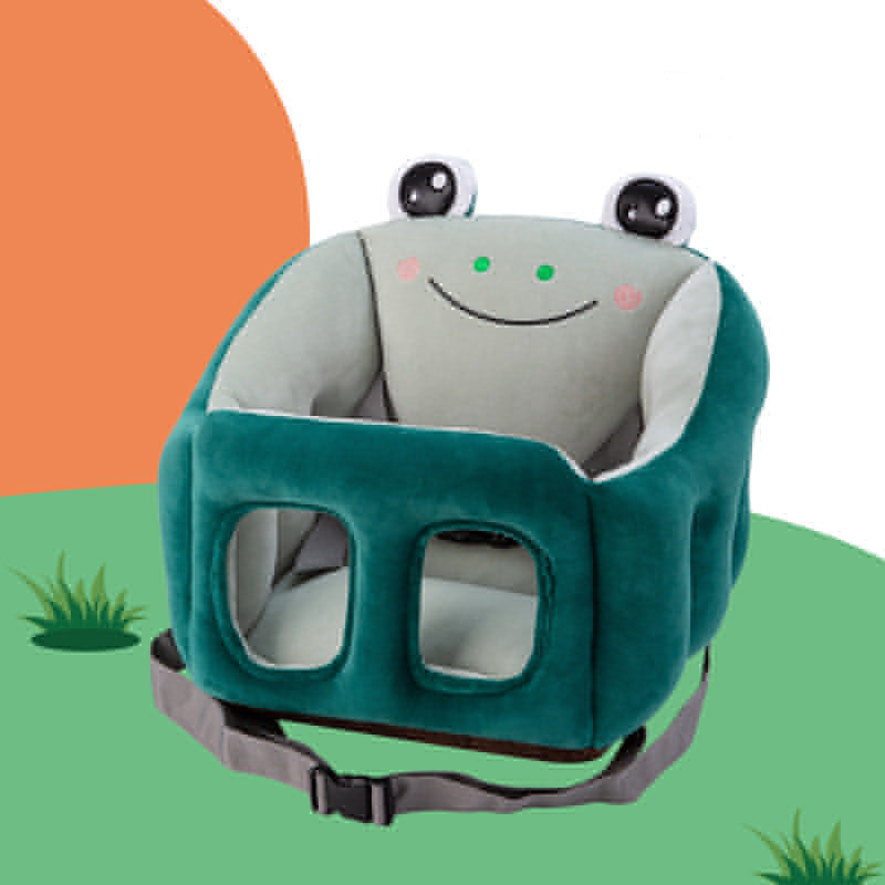 Plush children's chair in the shape of a frog with a smiling face, large eyes, and green fabric. It features open sides and a safety strap, set against a simple, colorful background.