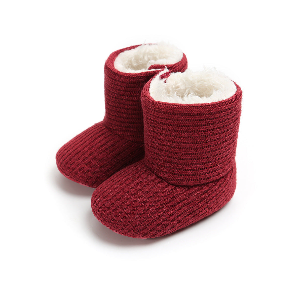Red knitted baby booties with soft white fleece lining, featuring ribbed texture. The booties are standing upright on a white background, showcasing their cozy design.
