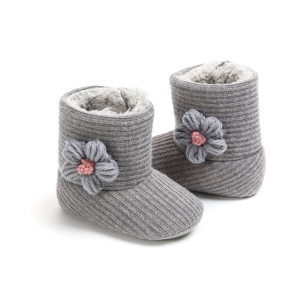Cozy gray knit baby booties with fluffy lining and decorative yarn flowers featuring pink centers. The ribbed texture adds charm and warmth, ideal for keeping tiny feet snug.