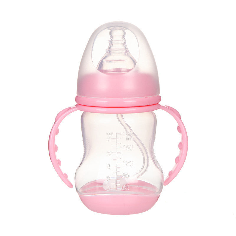 A clear baby bottle with a pink base and handles, marked with measurements in ounces and milliliters. It has a pink cap covering the nipple, designed for easy gripping.