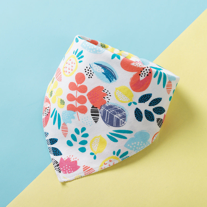 Colorful bandana with vibrant abstract leaf and fruit patterns in pink, blue, yellow, and orange, set against a blue and yellow background.