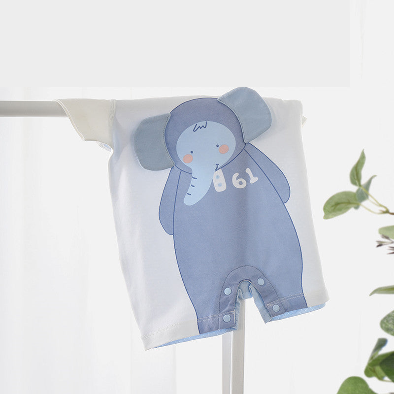 White baby romper with a cute blue elephant design featuring large ears and the number "61." The outfit has snap buttons at the bottom and hangs on a rack near green leaves.