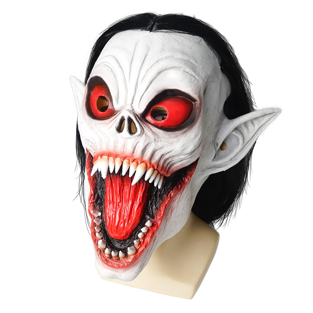 Horrifying mask with sharp fangs, red eyes, and long black hair. Features pointed ears and a wide, open mouth. The mask is white with deep red and black details.