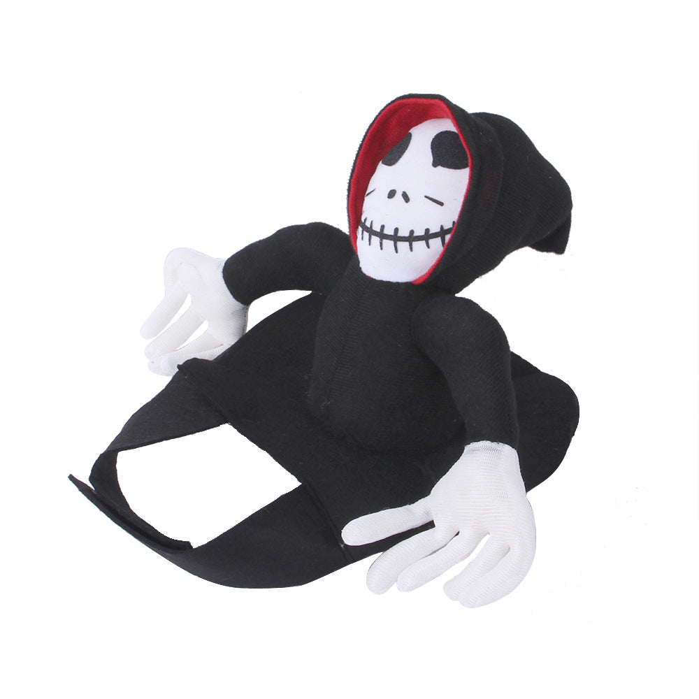 Stuffed toy resembling a skeleton, wearing a black hooded robe with a red-lined hood. The face features a stitched smile, black eyes, and white gloves.