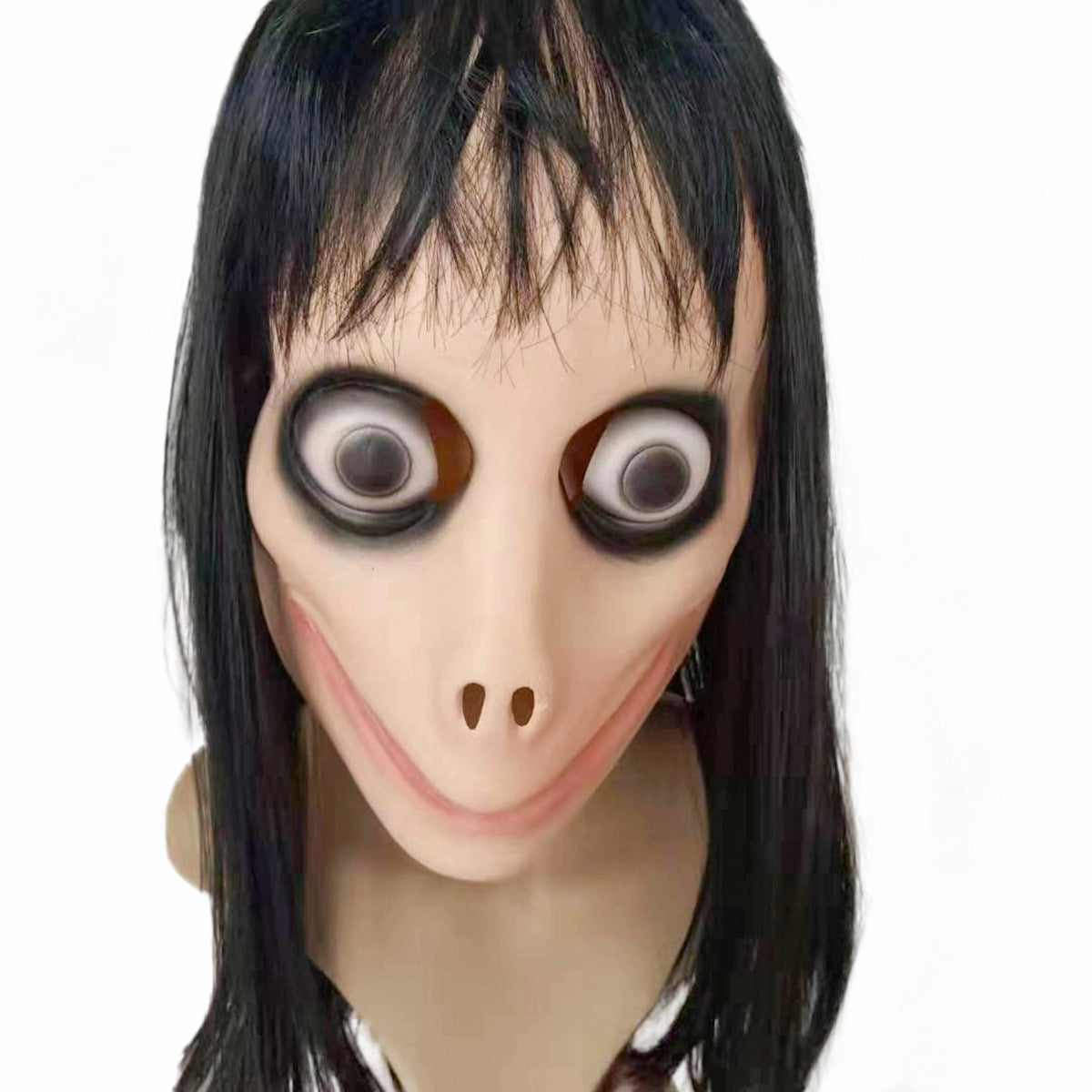 Creepy sculpture with exaggerated features: bulging eyes, wide grin, elongated nose, and dark hair. The unsettling figure stares directly with a haunting expression.