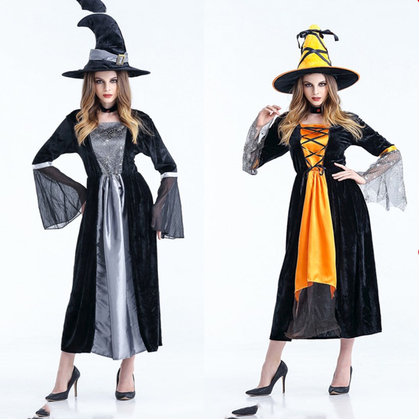 Two models in witch costumes: one in a black and silver gown with a tall black hat, the other in a black and orange dress with a matching orange-laced hat. Both wear heels.