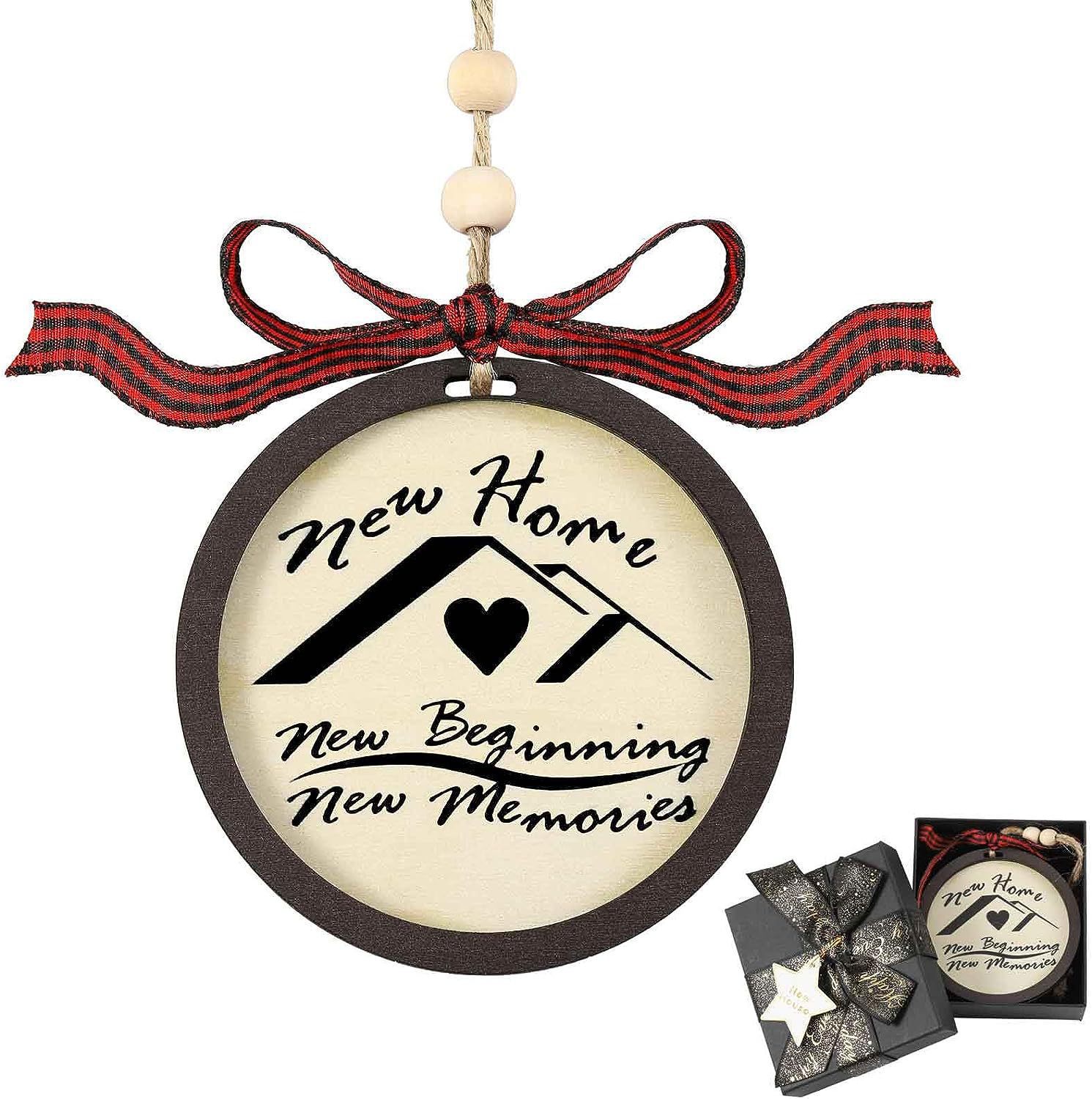 Round ornament with the text "New Home, New Beginning, New Memories," featuring a house design with a heart. Decorated with a plaid bow and beads, boxed as a gift.