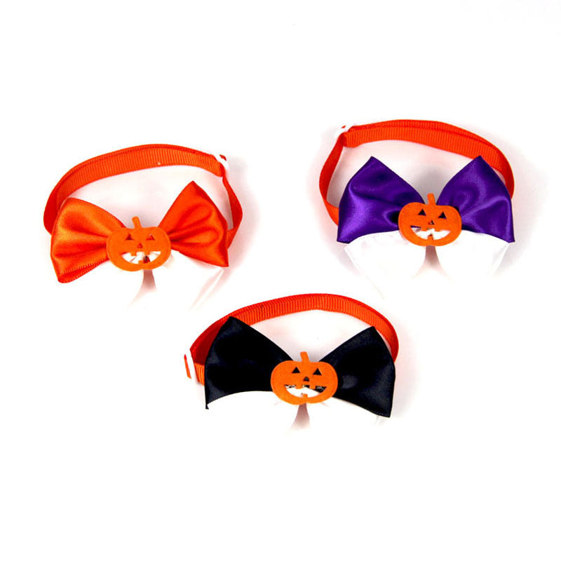 Three Halloween-themed bow ties with pumpkin decorations. The bows are in orange, purple, and black, each attached to an orange band, arranged against a white background.