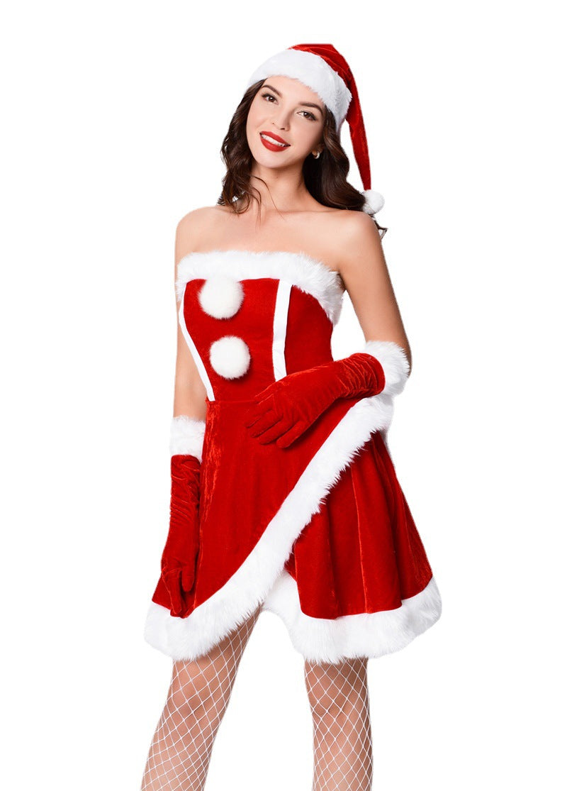 Woman in a festive Santa-style costume with a red strapless dress, white fur trim, red gloves, and a Santa hat, smiling against a white background.