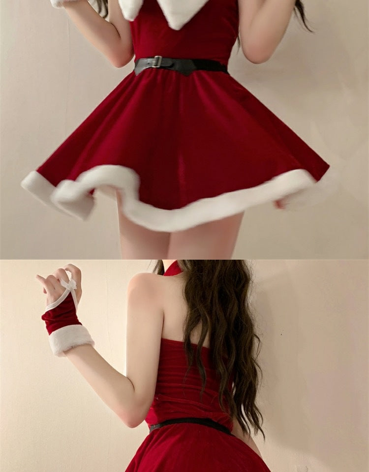 Person in a red velvet Santa dress with white fur trim, wearing a black belt. The outfit is complemented by red gloves with white fur. Long hair cascades down the back.