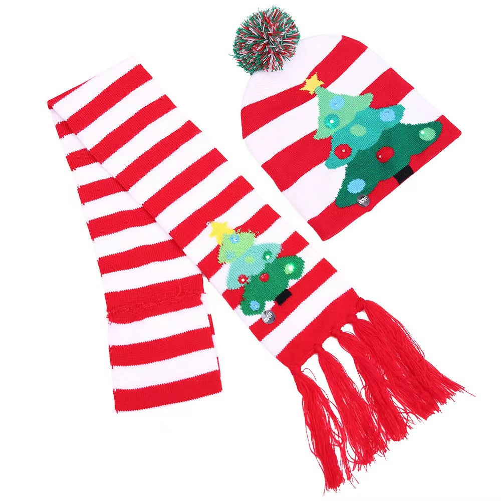 Red and white striped hat and scarf set with Christmas tree designs. The hat has a colorful pom-pom on top, while the scarf features tassels at the end.