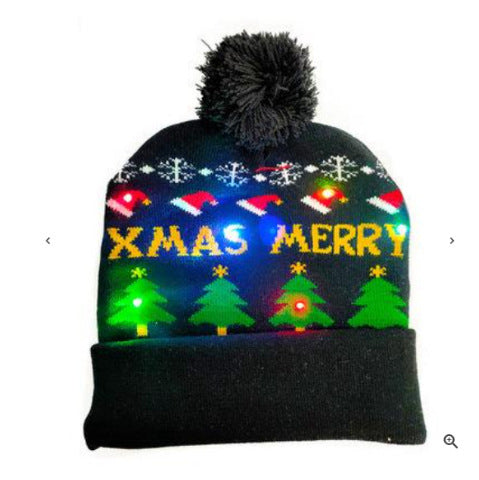 Black winter hat with "XMAS MERRY" text, snowflakes, Santa hats, and decorated Christmas trees. Features colorful LED lights and a black pom-pom on top.