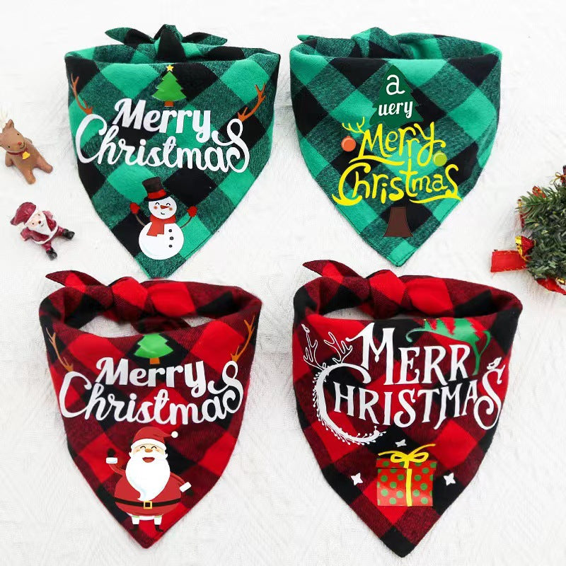 Four Christmas-themed bandanas with "Merry Christmas" designs, featuring snowmen, Santa, gifts, and Christmas trees, in red and green plaid patterns. Small festive figurines nearby.