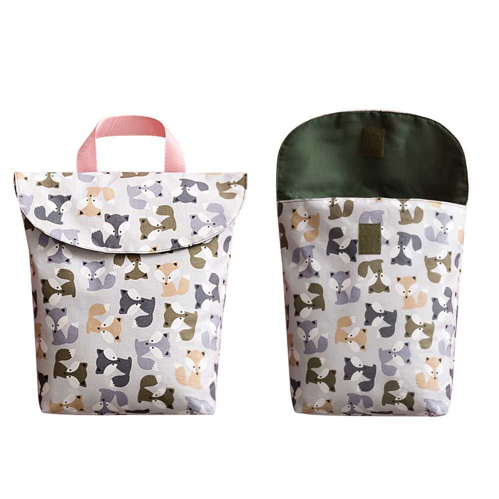 Two reusable sandwich bags with playful dog patterns. One bag is closed with a pink handle, while the other is open to reveal a green interior. The designs feature various dog shades.