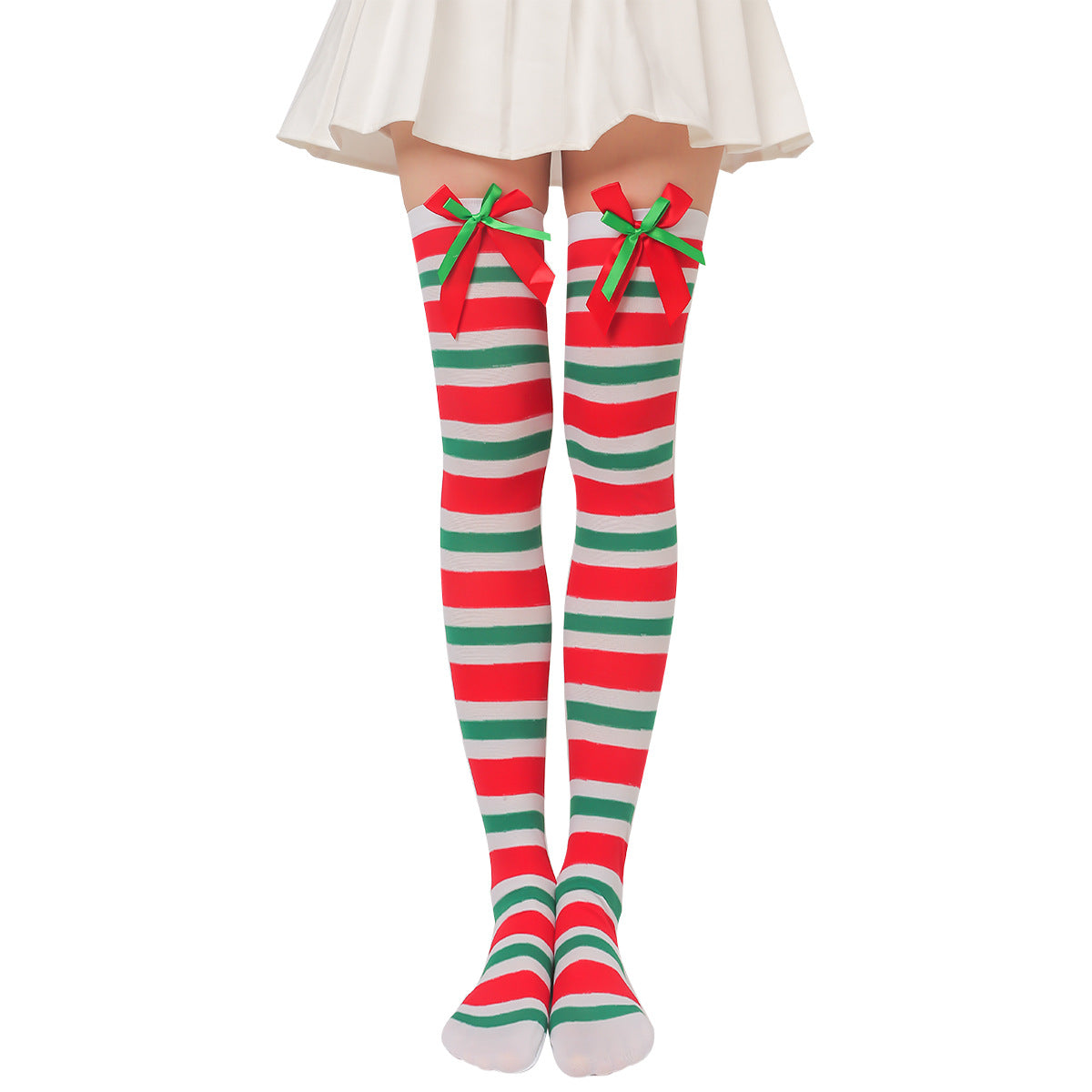 Person wearing thigh-high striped socks in red, white, and green, adorned with green and red bows at the tops. A white skirt partially visible above the knees.