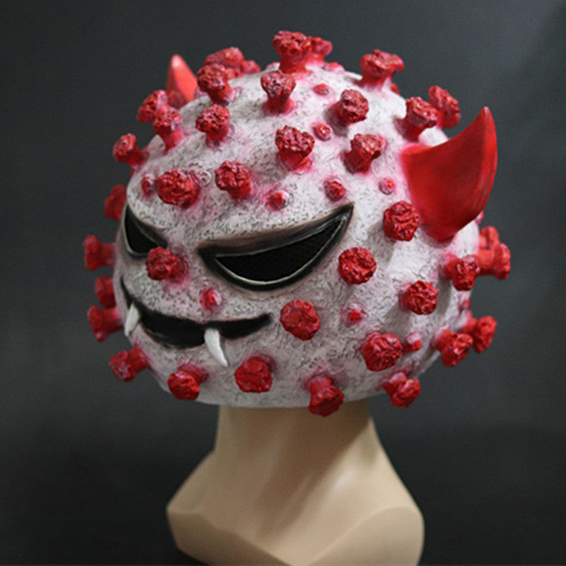 A mask designed to resemble a menacing virus with red spikes, devilish horns, sharp fangs, and angry eyes, set against a dark background.