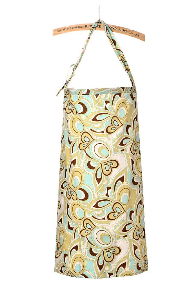 Colorful apron with retro floral pattern in teal, yellow, and brown hues, hanging on a wooden hanger. The design features abstract flower shapes and swirling motifs.