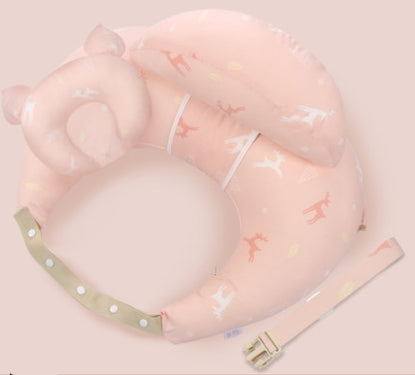 Pink infant neck pillow shaped like a bear, with deer and leaf patterns. It features a detachable beige strap with white polka dots and a buckle, designed for safety and support.