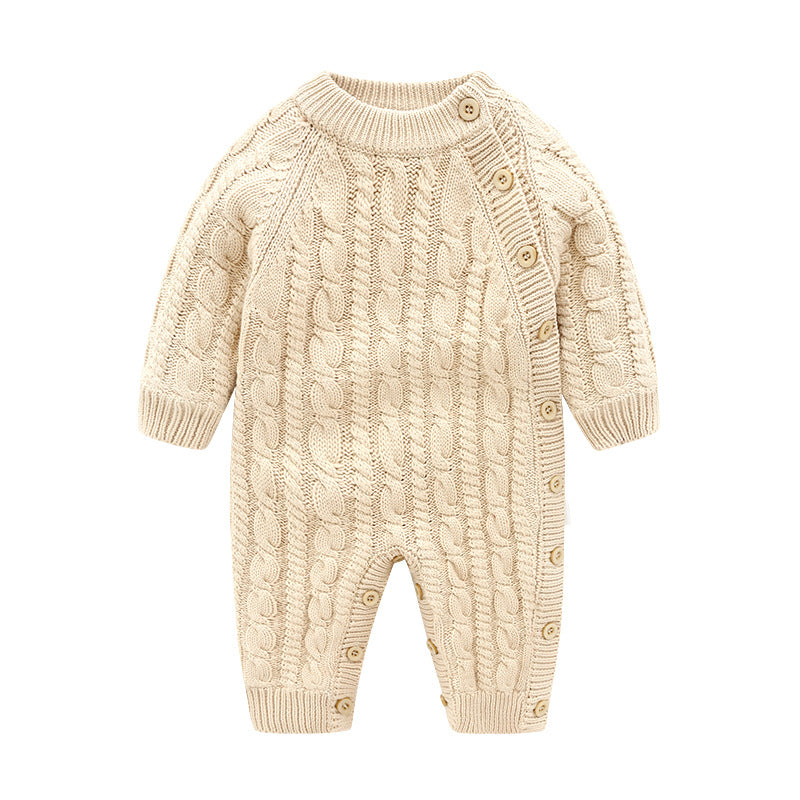 Cream-colored cable knit baby romper with long sleeves and a button-down side closure. Ribbed cuffs adorn the wrists and ankles for a comfortable fit.