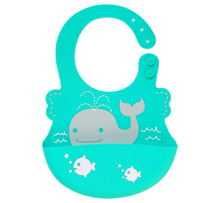 Teal silicone bib with a smiling gray whale design, featuring water sprays and small white fish. Two star-shaped buttons on the right side for adjustable fitting.