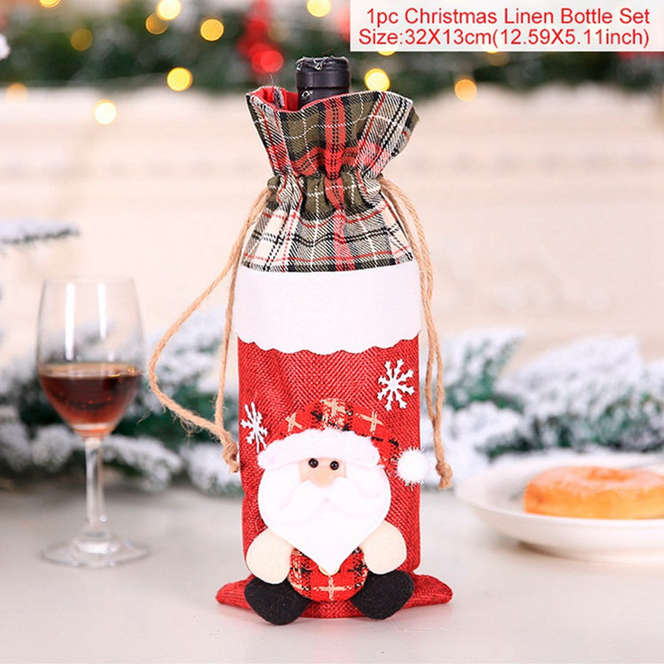 Festive bottle cover with Santa design, plaid top, and snowflake accents. Wine glass and pastry are visible in a Christmas-themed background with soft lights.